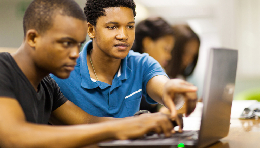 students looking at laptop