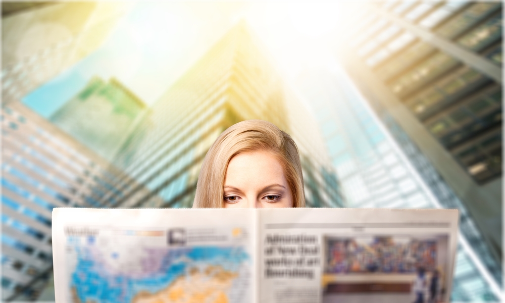 woman reading a newspaper