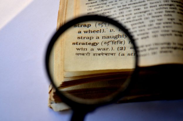 Strategy word shown behind a magnifying glass