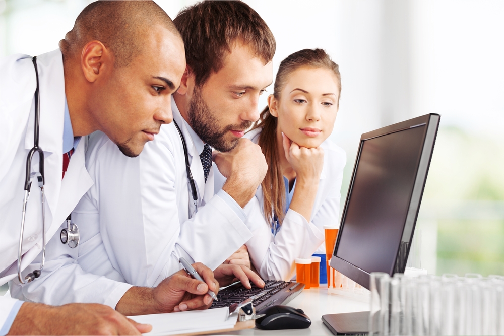 3 Doctors looking at a computer quizically