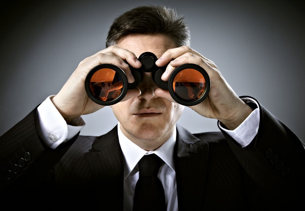 Man in suit with binoculars