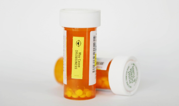 2 drug tablet bottles, orange with white tops