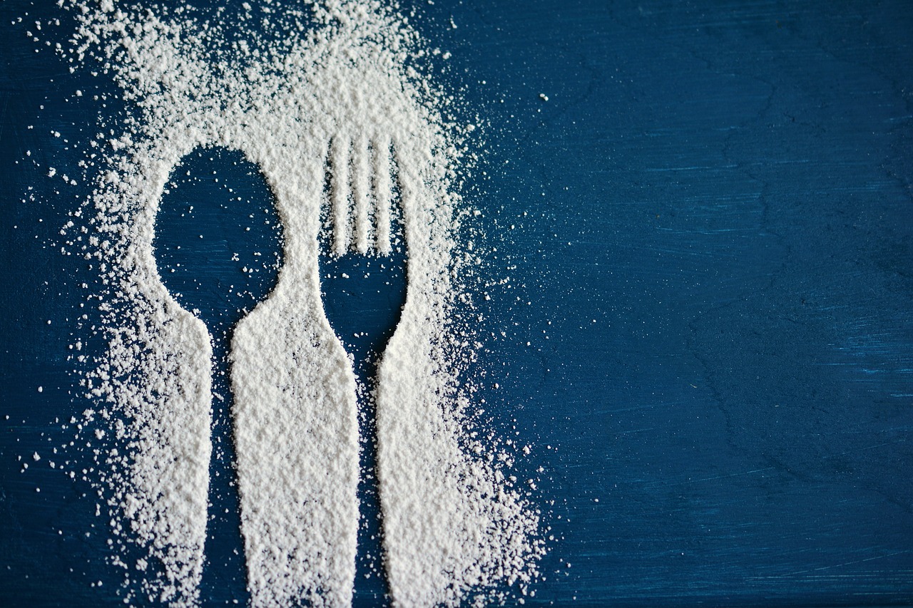 Spoon and fork outline shown in sugar